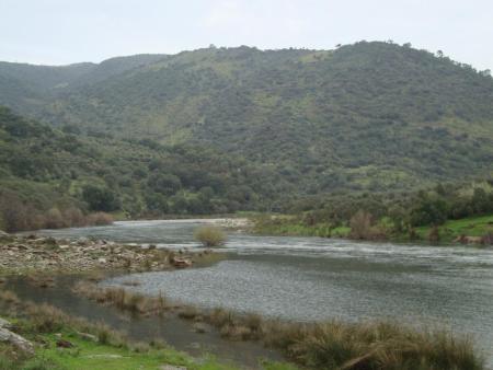 sabor, portugal, lake surrounded by green mountains and hills - cloudy sky 